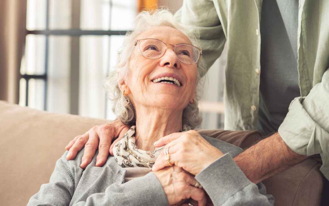 Comforting hand on shoulder of elderly person